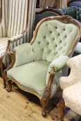 Victorian walnut and deep buttoned armchair with serpentine front seat on cabriole legs