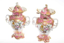 Pair of 19th Century Rockingham lidded vases with floral panels on pink,