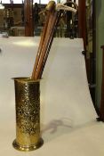 Embossed brass stick stand and four walking sticks
