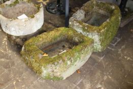 Two similar weathered stone troughs,