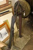 Vintage cast broom shank clamp on weathered stone mount