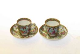A pair of Chinese Famille Rose cups and saucers
