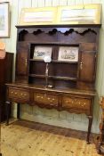 Period oak and mahogany three drawer cabriole leg dresser with shelf and cupboard back,