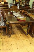 Late 19th Century/Early 20th Century extending dining table on turned legs with leaf and winder