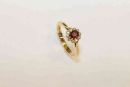 18 carat gold, oval ruby and round brilliant diamond cluster ring,
