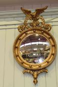 Circular gilt framed convex mirror with eagle crest