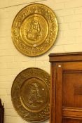 Pair of large circular embossed brass plaques,