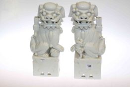Pair of white glazed pottery dogs of fo