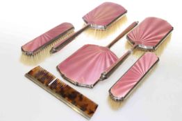 Silver and pink enamel dressing table set (5) and a silver -mounted comb (2)