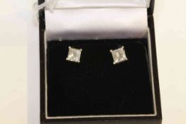 Pair of 14 carat gold and princess-cut diamond stud earrings, total diamond weight approximately 1.