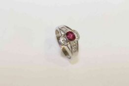 18 carat white gold, rubover oval ruby and channel set diamond ring,