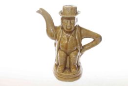 Salt-glazed teapot in the form of a seated toby,