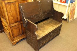 Oak monks bench carved with armorial crest