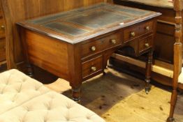 Victorian mahogany four drawer writing table having easel writing surface and raised on turned legs,