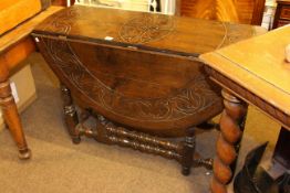 Victorian carved oak drop leaf dining table on turned legs