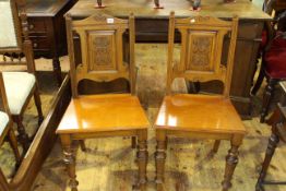 Pair Victorian oak carved panel back hall chairs