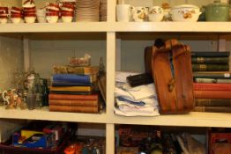 Books, linen, suitcase, cutlery, teaware, glassware including two decanters, old bottles,