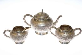 Fine Indian white metal three-piece tea service, with bamboo cast handles, chased with villagers,
