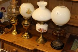 Four various brass boxed oil lamps with shades