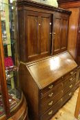 19th Century oak bureau bookcase having two panelled cupboard doors above a fall front and four