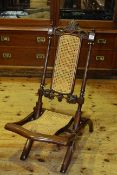 Victorian carved and bergere panelled folding chair