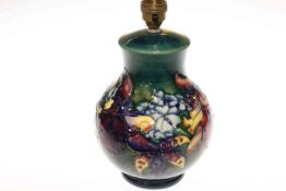 Moorcroft Pottery table lamp decorated with orchids on green ground