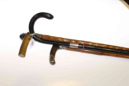 Four walking sticks with silver collars, carved head mounts,