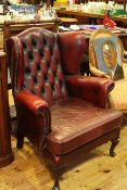 Ox blood buttoned leather wing back armchair on cabriole legs