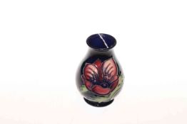 Moorcroft Pottery vase decorated with anemone on blue ground,