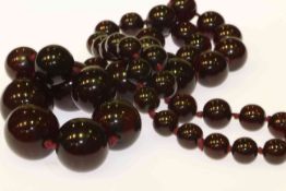 Cherry amber coloured bead necklace,