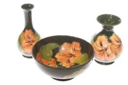 Three Moorcroft pieces with hibiscus on green ground