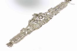 Art Deco diamond bracelet, the large symmetrical mount depicting scrolls and ribbon details,