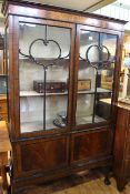 Early 20th Century mahogany china cabinet having two glazed panel doors above two cupboard doors on