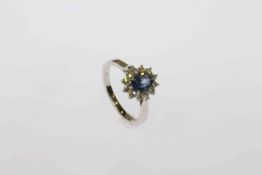 18 carat white gold, oval sapphire and round brilliant diamond cluster ring,