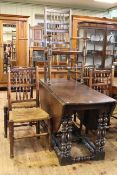 Large oak drop leaf dining table on jointed turned base together with five rush seated country