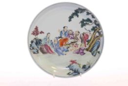 Chinese porcelain shallow dish with famille rose decoration of group of figures in outdoor setting,