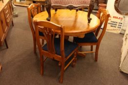 Circular pine extending dining table and four chairs together with a pine glazed door top double