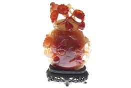 Chinese foliate carved agate vase and cover on stand, overall 16.
