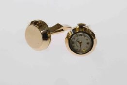 Pair of novelty cufflinks, one of the circular plaques set as a clock, with winder,