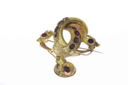 Early Victorian spinel set brooch, the heavily moulded swirl detail mount with subtle engraving,