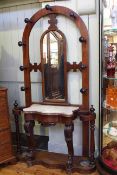 Victorian mahogany arched mirror back hallstand with marble topped serpentine centre,