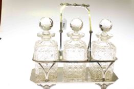 Silver-plated three-bottle tantalus, with swing handle, early 20th Century, 34.