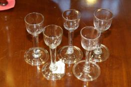 Collection of five folded foot wine glasses with plain stems,