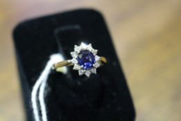 18 carat yellow gold oval sapphire and brilliant cut diamond cluster ring