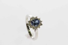 18 carat white gold oval sapphire and round brilliant diamond cluster ring