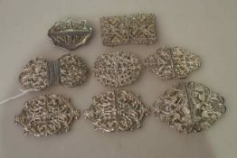 Eight silver two-section belt buckles