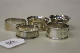 Four silver napkin rings and a plated ring (5) Silver 2.