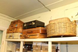 Seven vintage suitcases and two wicker baskets