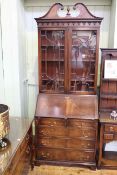 Mahogany bureau bookcase having two glazed panel doors above a fall front with five drawers below,