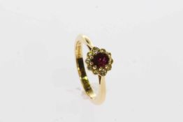 18 carat gold oval ruby and brilliant diamond cluster ring